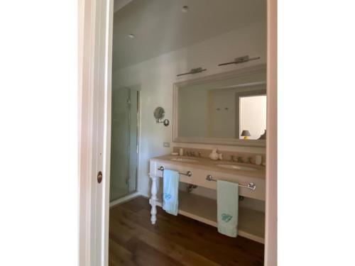 a bathroom with a sink and a mirror at Villa Rocchetta in Casa Mora