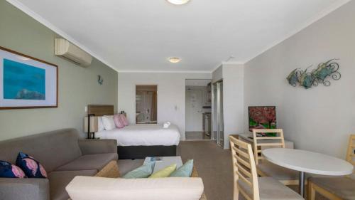 a living room with a couch and a bed at Breathtaking - Ettalong Beach Resort in Ettalong Beach