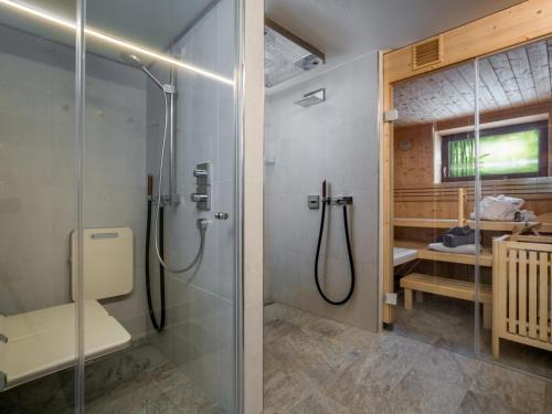 a bathroom with a shower and a glass shower stall at Luxury Central Kirchberg in Kirchberg in Tirol