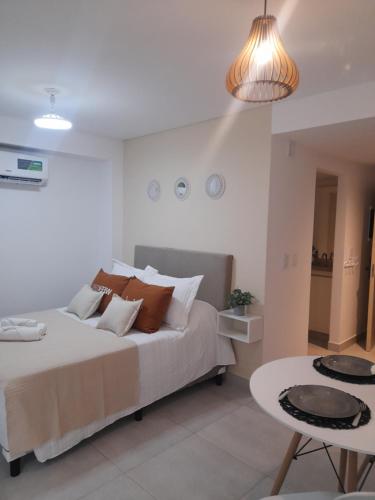 a bedroom with a large bed and a table at Legui Suites in Salta