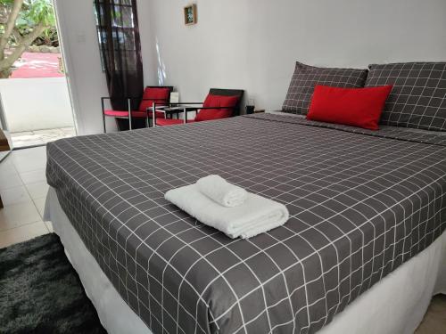 a black and white bed with a towel on it at Penthouse Suite - Chez Mango Villa in Olveston