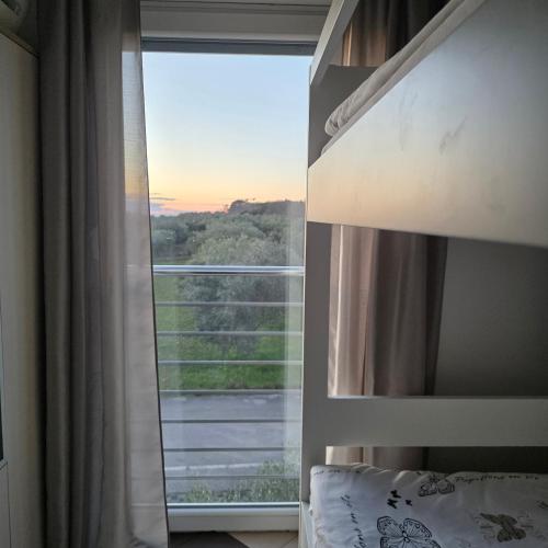 a bedroom with a window with a view at Apartment Mirella in Umag