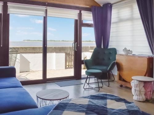 a living room with a view of the ocean at Angie's Beachside House in Saint Osyth