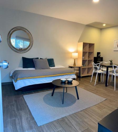 a bedroom with a bed and a table and chairs at LAZARO E - In the heart of San Pedro in Monterrey