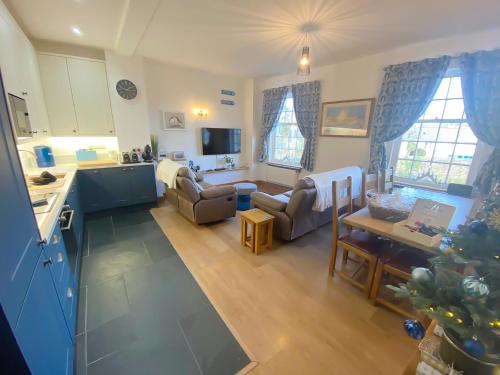a kitchen and living room with a christmas tree at The Boathouse in Appledore