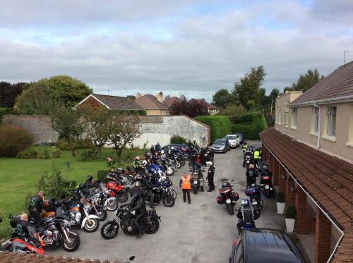 a large group of motorcycles parked in a driveway at The Gardens guest accommodation in Killarney