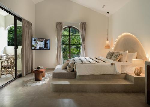 a bedroom with a bed and a large window at Coffee Routes in Thekkady