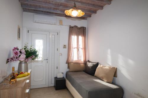 a living room with a couch and a window at Mykonos Town Aura Panorama with Private Terrace in Megali Ammos