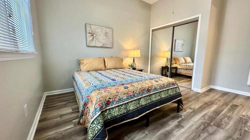 a bedroom with a bed and a mirror at 2200SQFT Coastal home on half Acre in Jacksonville