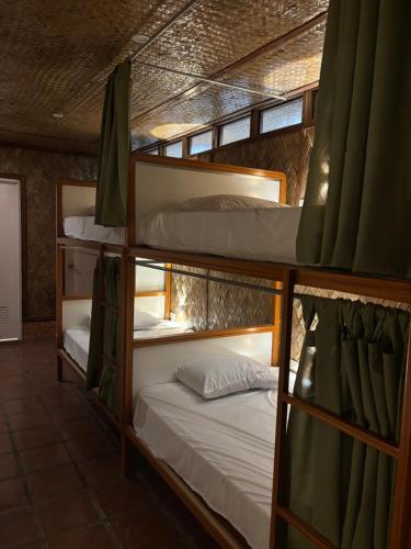 a group of bunk beds in a room at Jungle Hostel in Puerto Princesa City