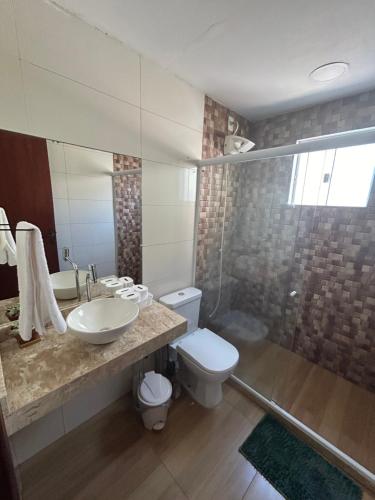 a bathroom with a sink and a toilet and a shower at Búzios Family House in Búzios
