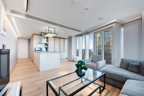 a living room with a couch and a table at Modern Stratford Westfield Olympic Village 1 Bedroom Apartment in London