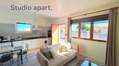 a living room with a couch and a table and a kitchen at Discovery Apartment in Santana