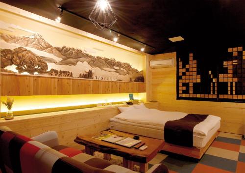 a bedroom with a bed and a table and a couch at PrincessPrincessAzumino in Azumino