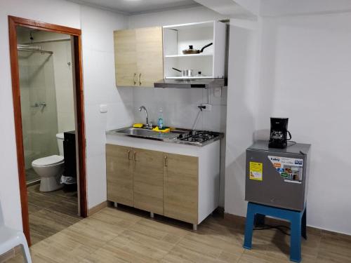 a small kitchen with a sink and a stove at Apartaestudios Santa Ana in Ruiosucio