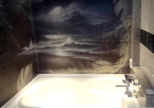 a bathroom with a painting on the wall of a sink at PrincessPrincessAzumino in Azumino