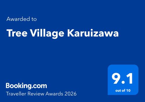 a blue sign with the words tree village karushkarma at Tree Village Karuizawa in Karuizawa