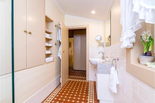a bathroom with a sink and a toilet at Winery Cottage in Tanunda