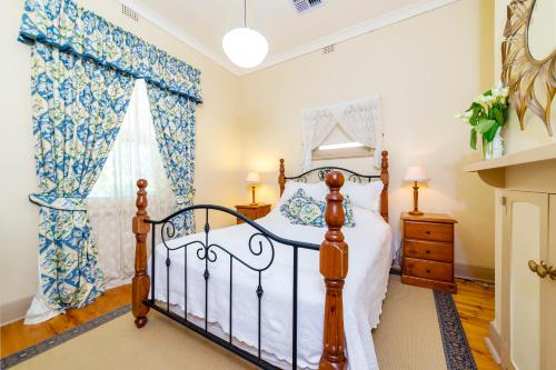 a bedroom with a bed and a window at Winery Cottage in Tanunda