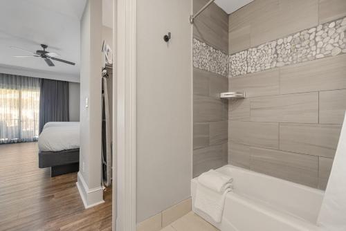 a bathroom with a bath tub and a bedroom at The Ridges Resort on Lake Chatuge in Young Harris