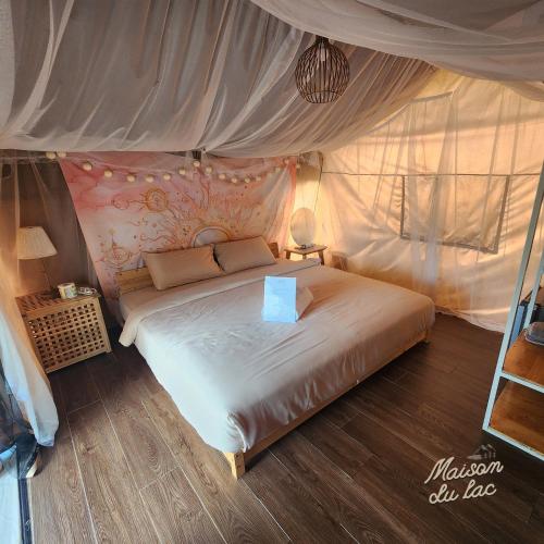 a bedroom with a bed in a tent at Maison Du Lac The Safari Tent in Wang Nam Khieo
