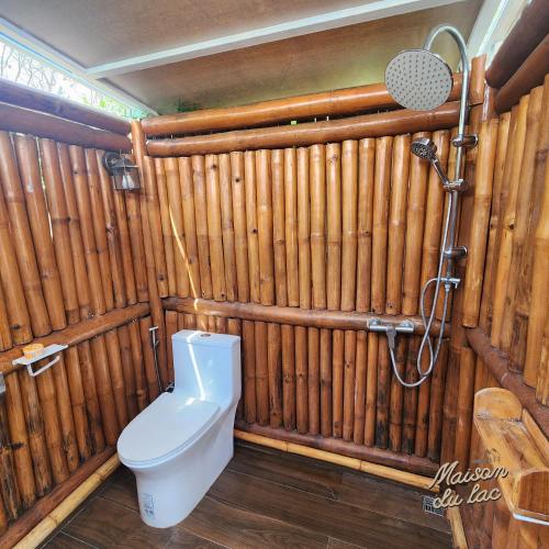 a bathroom with a toilet and a shower at Maison Du Lac The Safari Tent in Wang Nam Khieo