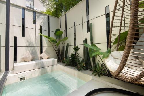 a hot tub on a patio with plants at Echo Beach Villas 6 in Canggu