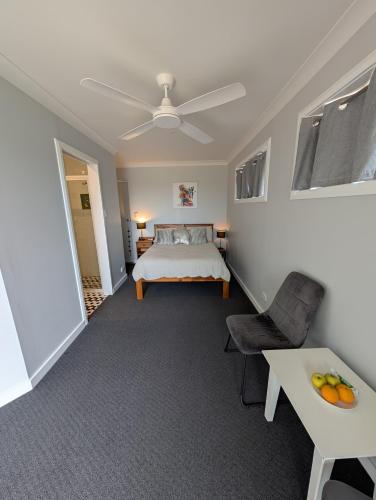 a bedroom with a bed and a table at The Elephants Nest in Victor Harbor
