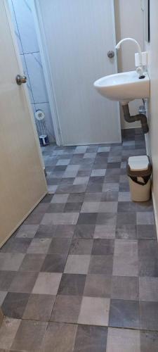 a bathroom with a sink and a toilet at Lotus Appartementen Nickerie in Majoor Fernandes