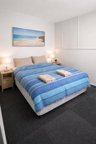 a bedroom with a large bed with two pillows on it at Broken Hill Tourist Lodge in Broken Hill