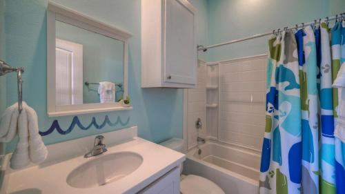 a bathroom with a sink and a toilet and a shower at Ocean Devotion by AvantStay in Port Aransas