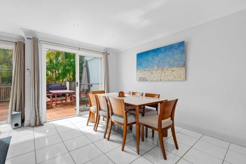 a dining room with a table and chairs at Paradise Waters 13 in Coffs Harbour