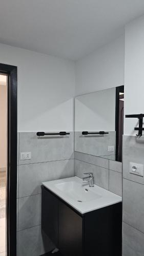 a bathroom with a sink and a mirror at Modern Hillside Retreat with Panoramic Views in Mussomeli