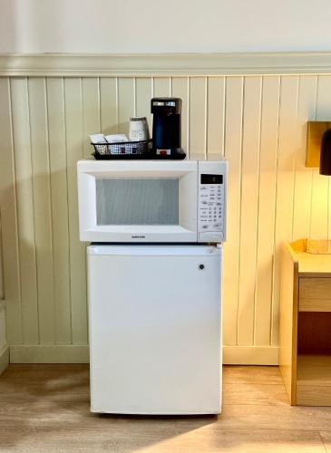 a microwave sitting on top of a white refrigerator at Pikes Peak Inn in Manitou Springs