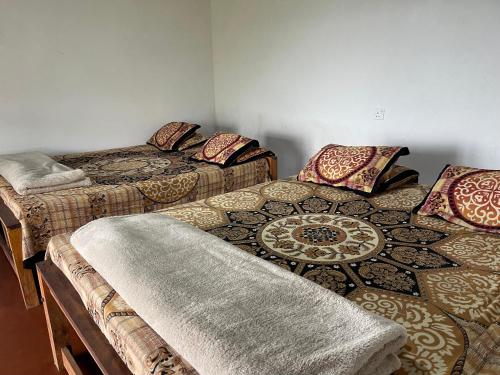 a room with two beds with pillows on them at Royal Mountain Edge ,Knuckles in Rangala