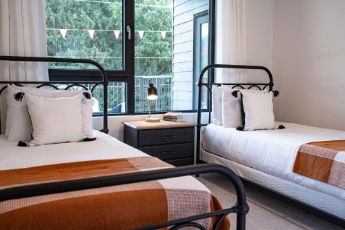 a bedroom with two beds and a window at Tucker's Place in Revelstoke