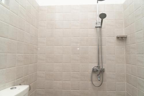 a bathroom with a shower with a toilet at Rugee R Villa in Negombo