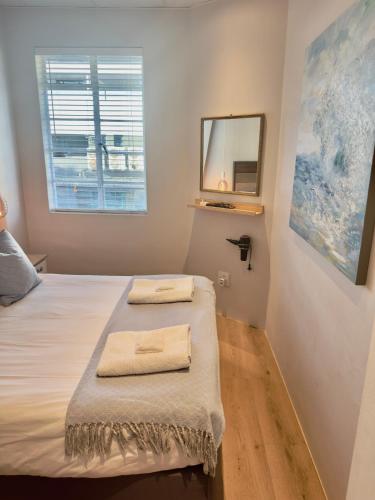 a bedroom with a bed with two towels on it at Kaneel Suiker - Paarl - Self Catering Apartment in Paarl