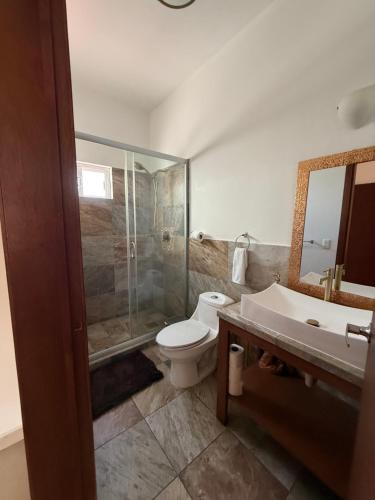 a bathroom with a toilet and a shower and a sink at Salvatierra Home in La Paz