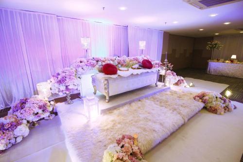 a room with a wedding altar with flowers and a bed at Seeds Hotel Premier Pudu Kuala Lumpur Previously Hotel Pudu Plaza KL in Kuala Lumpur