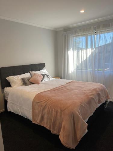 a bedroom with a large bed with a window at Hart Road Haven in Richmond