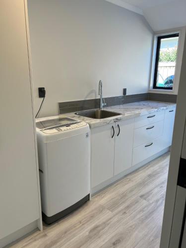 a kitchen with a sink and a dishwasher at Hart Road Haven in Richmond