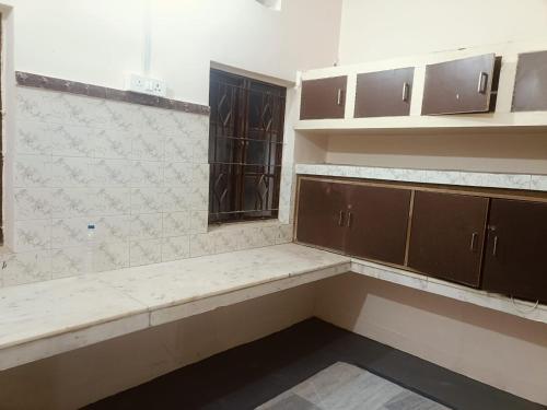 an empty kitchen with a counter and a window at Lotus palm in Deoghar