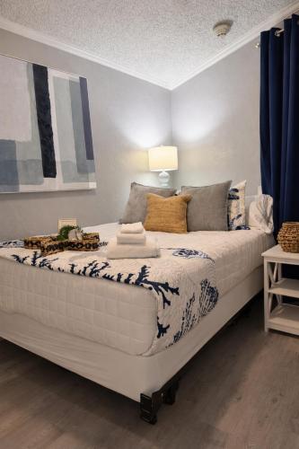 a large white bed in a room with blue curtains at Luxury Beach front Condo in Galveston