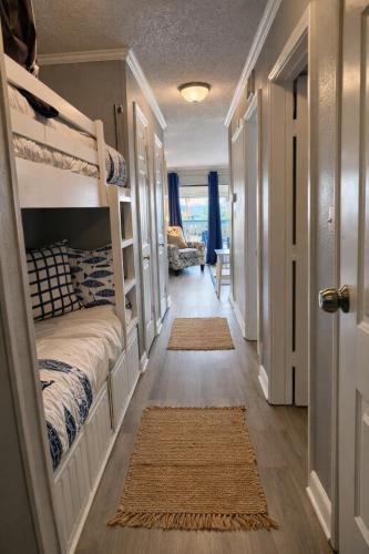 a hallway with two bunk beds in a room at Luxury Beach front Condo in Galveston