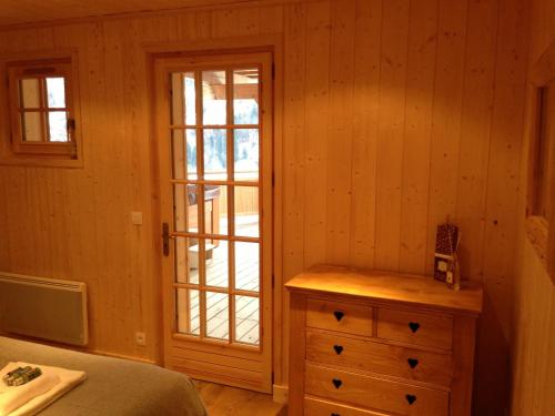 a bedroom with a bed and a dresser and a window at Chalet Marie Blanche in Saint-Gervais-les-Bains