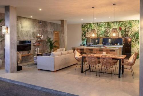 a kitchen and living room with a table and chairs at KARMA room in Villa ABSOLUTE Shared Villa in Canggu