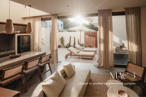 a living room with a couch and a table at MAE Villas Canggu in Canggu