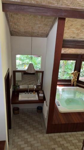a bathroom with a large tub and a sink at Casa do Fachoalto in Petrópolis