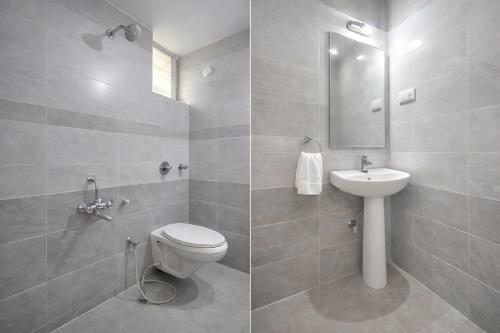 a bathroom with a toilet and a sink at Hotel Bhavishyaa Vrindavan in Vrindāvan